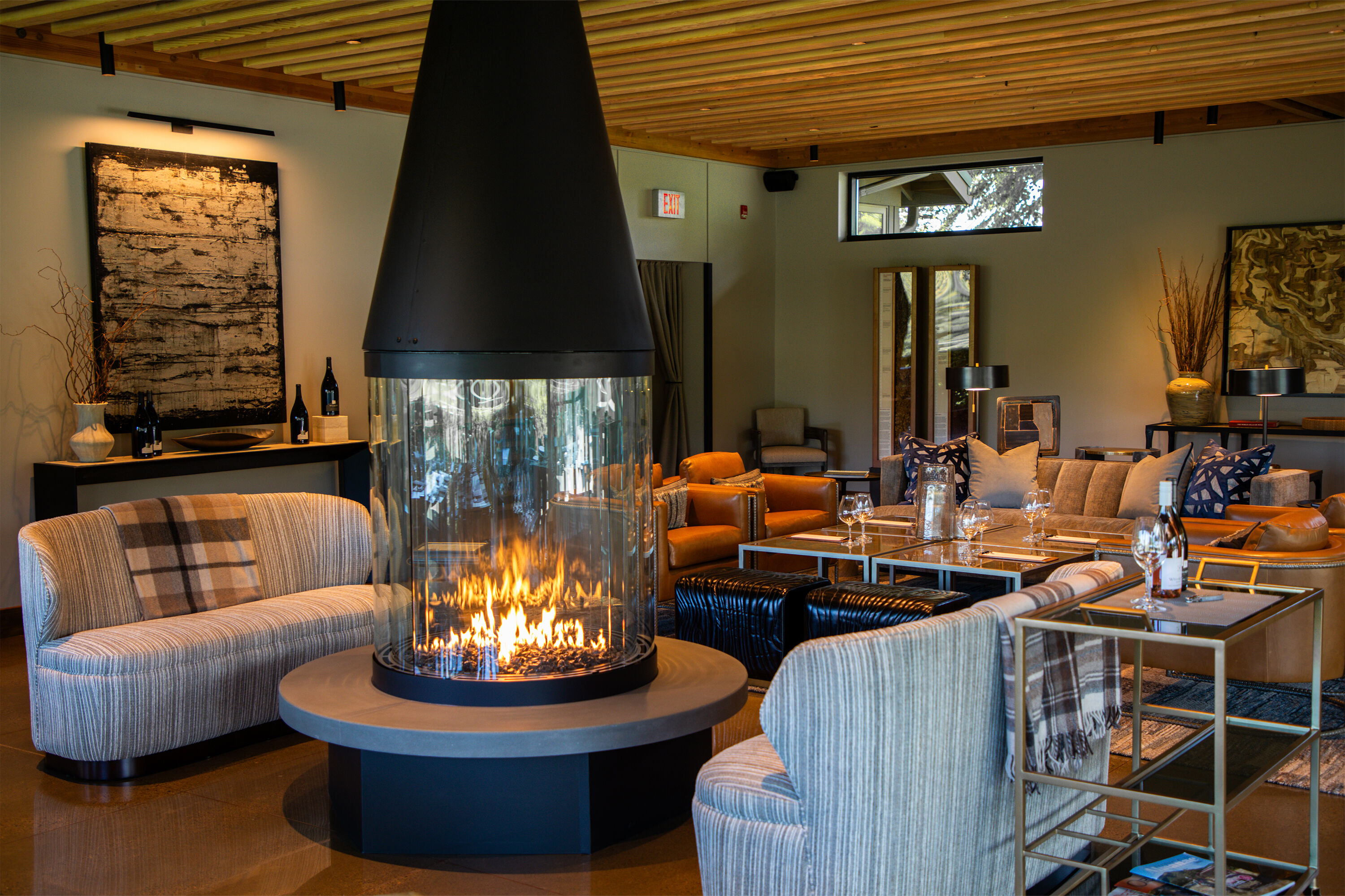 Full view of the WillaKenzie Tasting room with fire burning in fireplace.